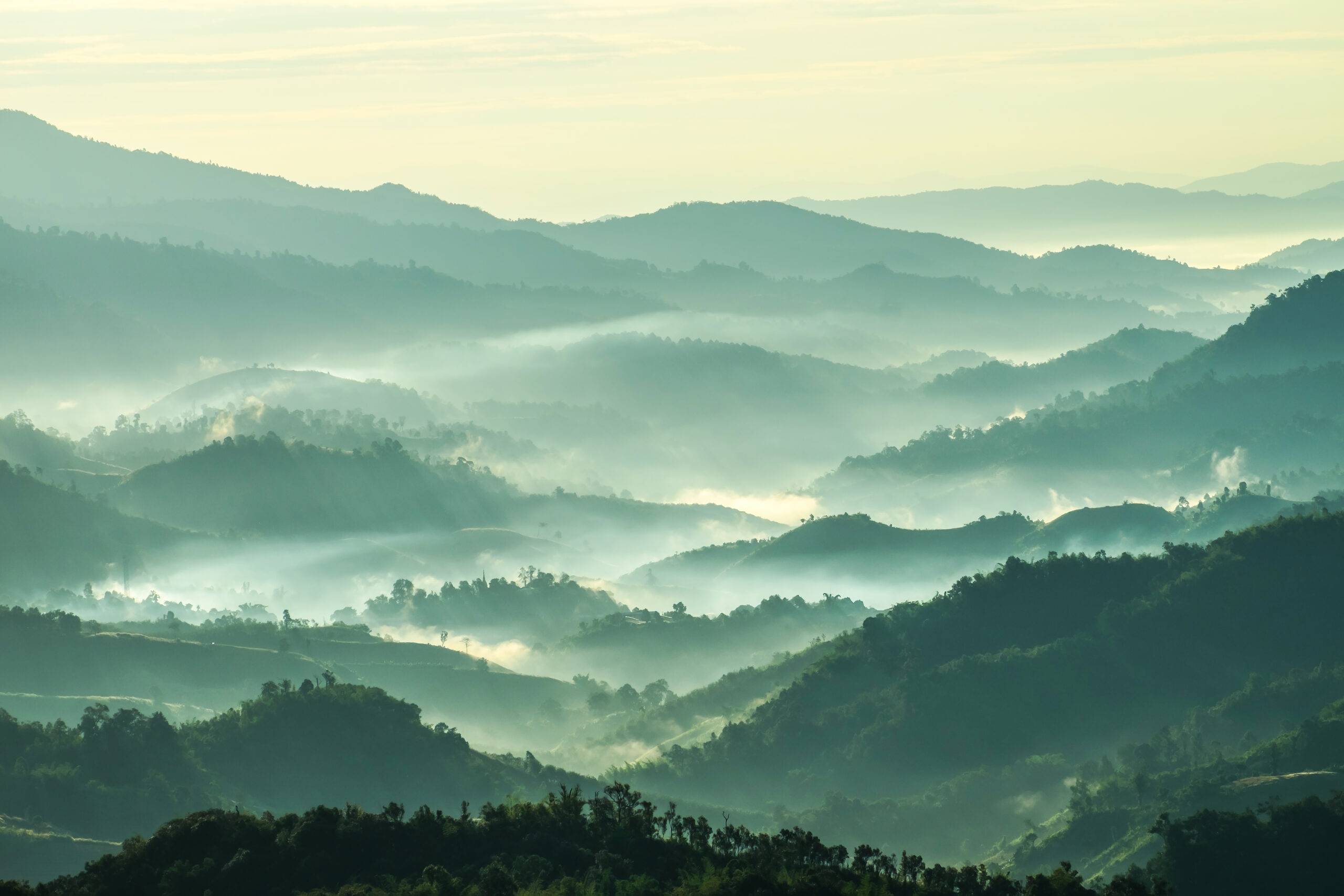 colouful mountain landscape covered in light fog